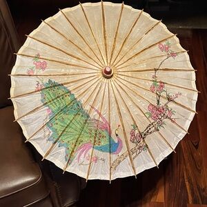 Elegant hand-painted Asian rice paper parasol with peacock and floral design.
